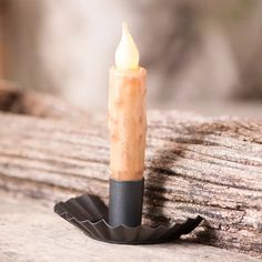 a candle that is on top of a piece of wood