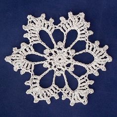 a crocheted snowflake on a blue background