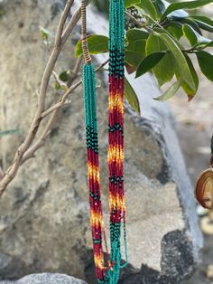 This necklace is made of various colors of small seed beads.  The colors of red blue and yellow represent a "tribal" style that adds to the uniqueness of the piece.   Great accessory with any outfit, casual or formal. Traditional Multicolor Beaded Earrings With Beaded Chain, Traditional Multicolor Beaded Chain Earrings, Hand-strung Multicolor Beaded Earrings For Festivals, Artisan Multicolor Hand-strung Beaded Earrings, Multicolor Hand-strung Beaded Earrings For Festivals, Red Bohemian Beaded Bracelet, Hippie Multicolor Hand-strung Beads, Red Handwoven Beaded Earrings For Festival, Artisan Red Beaded Necklaces Handwoven