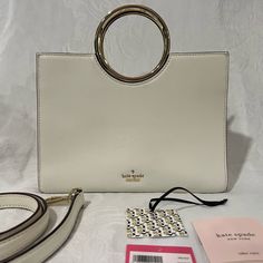 Kate Spade 25th Birthday Edition White Leather Rock Road “Sam” Handbag With Gold Handles And Detachable Shoulder Strap. Black And White Striped Lining With 4 Interior Pockets - 2 That Zip. Original Tags, Care Instructions And Dust Bag Included. Please Message Me With Any Questions. #Katespade #Birthday #Leather #Gold #Designer #Handbag Everyday White Satchel With Round Handle, Kate Spade Designer Top Handle Shoulder Bag, Designer Kate Spade Top Handle Shoulder Bag, White Evening Bag With Round Handle, White Bag With Round Handle For Everyday Use, Modern White Bag With Round Handle, Trendy White Kate Spade Bag, Kate Spade Designer Top Handle Bag, Kate Spade Shoulder Bag With Top Handle