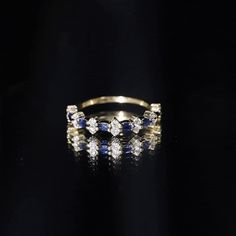 Product Details Surprise the one you love with this beautiful Blue Sapphire and Diamond Ring. Designed with a classic East West style, this half eternity ring features a gorgeous Round Shape blue sapphire as the center gemstone set in a prong setting. Accented with sparkling Diamond stones, this ring is crafted for a stunning and durable piece of jewelry. Show your love and commitment with this gorgeous ring. Product Information SKU SHP-RINGS0821183767 Width 1.8 mm Height 4 mm Weight 1.29 gm (Approximate) BLUE SAPPHIRE INFORMATION No.of Stones 7 Pieces Total Weight 0.21 Carat (Approximate) Dimension(approx) Marquise-1.50X3.00 mm-7 Pcs Color Blue Cut Brilliant Shape Marquise Setting Type Prong-Setting Quality Grade AAA DIAMOND INFORMATION No.of Stones 16 Pieces Total Weight 0.40 Carat (Appr Elegant Round Cut Blue Stackable Rings, Elegant Sapphire Jewelry With Half Eternity Design, Elegant Blue Diamond Promise Ring, Blue Diamond Stackable Promise Ring, Blue Stackable Diamond Promise Ring, Sapphire Half Eternity Diamond Ring For Promise, Elegant Sapphire Jewelry With Half Eternity, Elegant Sapphire Eternity Band For Formal Occasions, Sapphire Cubic Zirconia Half Eternity Promise Ring