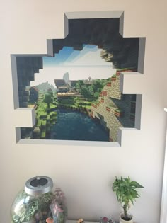 an image of a river in the middle of a wall hanging above a table with plants