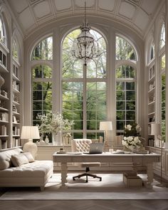 a living room filled with lots of furniture next to large windows and a chandelier