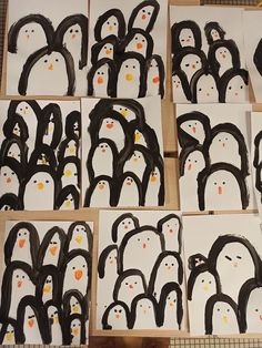 penguins are painted on white cards with black and orange dots