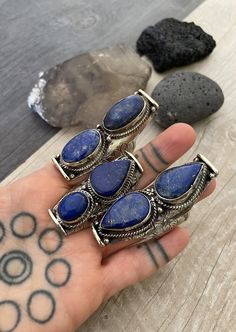 Unique statement large Lapis Lazuli stone rings. Each ring has a unique set of stones for you to choose from. As you can see, there is a number that represents each ring for you to pick your favorite. In one of the pictures you can see the dimensions of the biggest one and the smallest one, all the rest are in between. They are also size adjustable, the smallest size recommended is size 9.5, and can be open up to size 12-13 , it might create a gap in the back of the ring. A unique comfy statemen Bohemian Adjustable Crystal Ring With Large Stone, Bohemian Crystal Open Ring With Large Stone, Bohemian Rings With Large Stone For Gift, Bohemian Open Ring Jewelry With Large Stone, Bohemian Open Ring With Large Stone, Bohemian Adjustable Rings With Stones, Adjustable Bohemian Rings With Stones, Bohemian Gemstone Ring Jewelry, Bohemian Crystal Ring With Stones