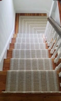 the stairs are lined with carpet and white railings