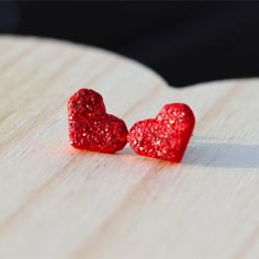 These stunning red glitter heart stud earrings are even prettier in person!  They're lightweight and hypoallergenic stainless steel for sensitive ears.  These heart love stud earrings are perfect for Valentine's Day and everyday wear.   They're handmade with polymer clay.  These sweet earrings look amazing with jeans and your favorite top as well as dresses and skirts.  You can dress them up or down. Earring Details ❤️ Hypoallergenic stainless steel posts for sensitive ears ❤️ Measure approximately 12mm in diameter ❤️ Soft clear silicone earrings backings for comfort ❤️ Packaged on a high quality earring card and in a gift box with satin ribbon ❤️ Handmade with polymer clay  Shop our entire collection of Valentine's Day earrings here... https://www.etsy.com/shop/LakeandLark?ref=seller-plat Heart-shaped Glitter Earrings For Gifts, Heart Shaped Glitter Earrings For Gift, Glitter Heart Earrings As Gift, Red Glitter Earrings For Gift, Glitter Red Earrings For Gifts, Red Hypoallergenic Heart Earrings For Valentine's Day, Clay Earrings Valentines, Stud Earrings Polymer Clay, Valentines Day Earrings