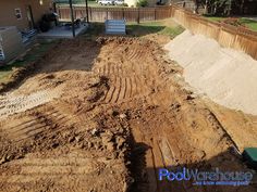 a large pile of dirt sitting in the middle of a yard