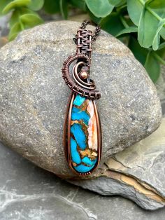 This stunning Spiny Oyster Copper Turquoise Stone with splashes of Turquoise and orange has been wrapped in Handwoven Copper and dangles from an adjustable 16-18 inch copper chain.  A patina process was applied to give this piece a rich, antiqued look.  This beautiful statement piece would be a great addition to any wardrobe. Artisan Handmade Turquoise Copper Necklace, Bohemian Jewelry In Copper Wire With Patina, Handmade Earthy Turquoise Necklace For Gift, Artisan Handmade Copper Turquoise Necklace, Unique Turquoise Copper Necklaces, Unique Turquoise Copper Necklace, Handmade Turquoise Copper Wire Necklace, Artisan Turquoise Hand Wrapped Necklaces, Artisan Hand Wrapped Turquoise Necklaces