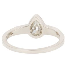 An inverted pear-shaped diamond is the stunning focal point of this one-of-a-kind ring. The bezel setting highlights the unique shape of the stone and draws the eye into its shiny depths. Angled geometric shoulders flank the center setting in Lauren Wolf's signature edgy aesthetic.Stones: .62ct White Inverted Pear-shape DiamondMetal: 18k White GoldMeasurements: Setting length: 13.4mm, Stone length: 4.5mm, Setting width: 8mm, Setting height: 3mm, Band width: 2.1-1.2mmSize 5.75 in stock Shipping a Teardrop Diamond Cut Diamond Ring, Teardrop Single Diamond Promise Ring, Teardrop Diamond Ring With Single Diamond For Anniversary, Teardrop Diamond Ring With Single Diamond, Teardrop Single Diamond Ring, Classic Teardrop Bezel Set Ring, Formal Teardrop Ring With Single Cut Diamonds, Modern Teardrop Diamond Ring For Formal Events, Modern Teardrop Diamond Ring For Formal Occasions