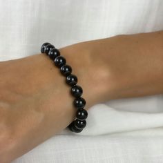 This beautiful black beaded bracelet is made with 8mm black tourmaline beads. Tourmaline is known for its unique ability to emit negative ions, which are believed by many ancient cultures to have spiritual significance. The bracelet is perfect for anyone looking for deep meaningful meditation on their aura or adding a touch of style to their outfit. Whether you wear it as a fashion statement or use it as a tool for meditation and a spiritual symbol, this bracelet is sure to become one of your favorite accessories.

 

 	Free Shipping 2 Days
 	Size: Adjustable, 8MM
 	Material: Authentic Stone, Black Tourmaline
 	Color: Black
 	Style: Beaded Bracelet Obsidian Round Beads Bracelets For Meditation, Obsidian Round Beads Bracelet For Meditation, Obsidian Beaded Bracelets For Healing, Spiritual Obsidian Round Beads Bracelet, Spiritual Obsidian Bracelet With Round Beads, Spiritual Black Beads Crystal Bracelet For Healing, Obsidian 8mm Beads Bracelet For Meditation, Healing Obsidian Beaded Bracelets With 8mm Beads, Black Pearl Bracelet With Round Beads