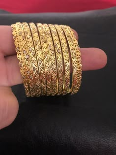 Intricate and classic. Pure silver 92.5 bangles! The details worth falling for❤️ A pure handcrafted and 24 KT gold plating over pure silver 92.5 bangles set, this festive season. Love these creations!! Absolutely stunning Bangles set : 8 piece Bangles set included: 6 bangles and two kadas Size : 2.6 Silver weight: 80.00 Garam and 200.00 milligrams Can be customize in any size. Made to order and shipping time 4-6 weeks. Hallmarked Silver Bangle For Festive Occasions, Festive Silver Hallmarked Bangle, Silver Chandbali Bangle For Diwali, Traditional Bangle Jewelry For Anniversary, Silver Festive Bangle For Anniversary, Silver Bangle For Anniversary And Festive Occasions, Festive Silver Bangle For Anniversary, Ornate Hand Set Round Jewelry, Hand Set Yellow Gold Chandbali Bangle