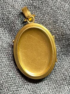 ". This beautiful oval locket has that gorgeous Victorian \"bloom\" to the gold that cannot be duplicated. It really can't be duplicated because the process has been illegal for almost 100 years now. The bale is an abstract fleur de lis shape. This locket is plated in 18k, thick enough to test 18k on the electronic tester! This locket does not have removable photo rings, but a printed picture could be carefully pressed in so it sits under the edge. I just print from my home printer on photo pape Classic Oval Locket Necklace Stamped 14k, Luxury Yellow Gold Oval Locket Necklace, Gold Oval Link Locket Necklace For Formal Occasions, Gold Oval Link Locket Necklace With Polished Finish, Classic Gold Oval Locket Necklace, Luxury Oval Locket Jewelry, Yellow Gold Oval Link Locket Necklace, Yellow Gold Oval Locket Necklace, Luxury Oval Locket Necklace As Gift