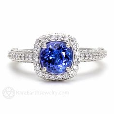 a tan and white gold ring with a blue sapphire in the center, surrounded by diamonds