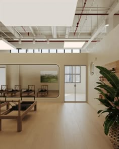 an empty room with tables and benches in the foreground, large windows on the far wall