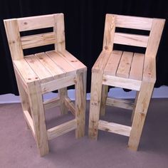 two wooden chairs sitting next to each other