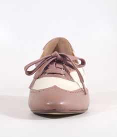 These delightful 1950s saddle shoes from Chelsea Crew blend classic elegance with a playful spirit, featuring a stylish mauve and bone color scheme that’s perfect for any outfit. The chic perforation detail adds a touch of whimsy, while the lace-up vamp ensures you’ll stay comfy all day long. Complete with a 1 inch heel.This is a Special Order item, please allow a 2-3 day handling time.Sizing runs small, if you're in between sizes, size up.Available while supplies last. Saddle Shoes, Bone Color, The Chic, Classic Elegance, Unique Vintage, Color Scheme, Saddle, 1 Inch, Color Schemes