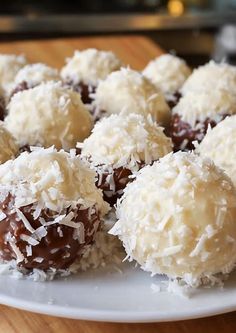 chocolate covered coconut balls on a white plate