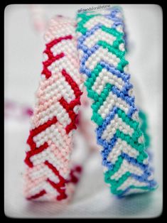 two colorful bracelets sitting next to each other