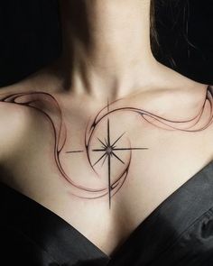 a woman's chest with a compass tattoo on it