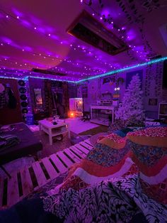 a living room filled with lots of furniture under purple lights