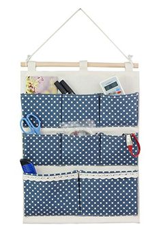 a hanging organizer with blue and white polka dots on the bottom, holding various items