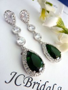 This classy earring features a long LARGE  emerald green peardrop cubic zirconia (20 X 15 mm) with multi small zirconias around it, dangling from 2 round cubic zirconia connectors,  with a white gold plated peardrop cubic zirconia post earring, the ear post is made of sterling silver.Size: 5.5 x 1.5 cm or about 2.6 inches long.Earring can be shorten to suit your need, just let me know :)The last picture shows an emerald green cubic zirconia worn by a mannequin.Other colour is also available:1. E Classic Green Pear Shaped Earrings, Classic Green Pear-shaped Earrings, Green Pear-shaped Earrings For Anniversary, Green Teardrop Wedding Earrings, Formal Green Teardrop Drop Earrings, Elegant May Birthstone Teardrop Earrings, Green Teardrop Dangle Earrings For Wedding, Green Teardrop Earrings For Wedding, Green Teardrop Earrings For Formal Occasions