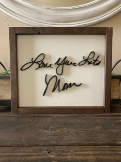 a framed sign that says, but you're not mom on the inside of it