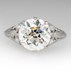 an antique style diamond ring with filigrees