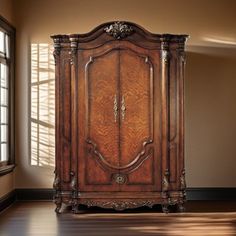 an ornate wooden armoire in the corner of a room with wood floors and windows