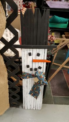 a snowman made out of wood and fabric