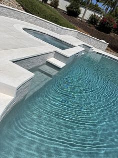 an empty swimming pool with steps leading up to it