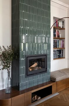 a living room with a fireplace and bookshelves on the wall next to it