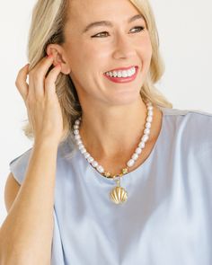 Our Marbella Pearl Necklace is the epitome of classy and timeless style. Connected to the pendant by our signature Bentley Beads, freshwater pearls give this piece an heirloom feel. Wear it as an accessory to your beachside ensemble with our Marbella Studs or as the perfect piece to complement your happy hour mini dress. Elegant Beach Jewelry With Gemstone Beads, Elegant Shell-shaped Pearl Drop Necklace, Elegant Polished Beads Necklace For Beach, Elegant Single Strand Shell Necklace For Beach, Elegant Shell Pendant Necklace For Beach, White Shell-shaped Jewelry With Pearl Pendant, Elegant Pendant Shell Necklace For Beach, Elegant Mother Of Pearl Beach Necklace, White Ocean-inspired Shell Necklace With Pearl Pendant