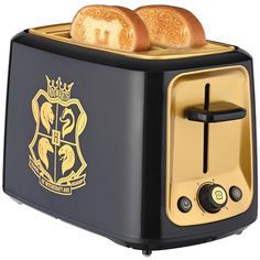 two slices of toast sitting on top of a black and gold plated toaster