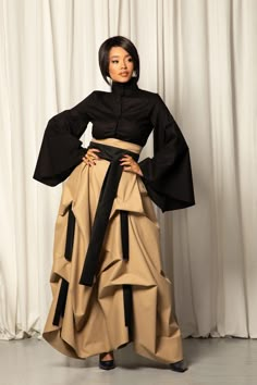 Elevate your style with this beige avant-garde skirt, crafted from premium cotton gabardine for a structured and sophisticated look. This striking piece features a long belt that flows with graceful movement, complemented by smaller belts that add unique layers and depth to its design. The neutral beige hue enhances its versatility, making it easy to style while retaining an avant-garde edge. This skirt combines elegance with an innovative twist, perfect for those who love bold, artistic fashion. 🌀 IMPORTANT: THE SHIRT IS NOT INCLUDED. However, it is also one of my designs, so if you are looking to complete your outfit, check it out here: KEY FEATURES: - High waist  - Long belt - Floor length - Zipper at the back - The additional small belts and a long belt are always black - Custom size Avante Grande Fashion, Avante Garde Outfit, Afropunk Outfits, Avant Garde Fashion Street, Avant Garde Skirt, Unique Skirts Design, Plus Size High Fashion, How To Wear Thigh High Boots, Futuristic Elegance