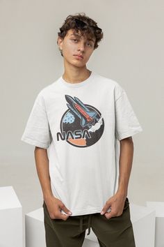 The Space Shuttle, a true icon for any aspiring space traveler! These graphics are retro and futuristic at the same time. This tee will remind anyone around you that there is a whole universe out there beyond the Earth. Blast off! ✅ Blank tee - our favorite Bella+Canvas 3001 ✅ 100% Airlume combed and ring-spun cotton ✅ Unisex fit, true to size ✅ Soft and comfortable ✅ Pre-shrunk fabric ✅ Printed in the USA with water-based, non-toxic ink Nasa Tshirt, Nasa Gifts, I Can Read Books, Nasa Shirt, Nasa Logo, Whole Universe, Space Gift, Retro T Shirt, Space Shuttle