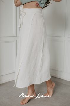 The beautiful midi-length wrap skirt "Iris" by AmourLinen is a versatile addition to any wardrobe. Its wrap style allows for simple outfits with sneakers and a top or a stylish beachy look with a swimsuit. Wear it to work, a picnic, or even a bigger occasion, such as a wedding! Choose from 13 colors and 2 sizes. White Wrap Skirt Outfit, Elegant Long Skirt With Tie Waist, Elegant Cotton Asymmetrical Maxi Skirt, Elegant Linen Bottoms For Day Out, Elegant Asymmetrical Summer Wrap Skirt, Elegant Asymmetrical Wrap Skirt For Summer, Elegant Summer Skirt With Tie Waist, Chic Wrap Lined Skirt, Elegant Wrap Skirt With Lining