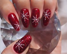 These beautiful hand drawn snowflakes lie on a red glittery gel that catches the light and flayed glistens from day to night.  These are made from Apres gel nails which are thicker and more durable than your average press on nails. They're easy to use and with proper care and removal can be used over and over again! These luxury press on nails will give you the perfect manicure within minutes. You receive- * Easy to follow instructions * 10 press on nails * Cuticle pusher * Nail buffer * Alcohol Stylish Nails Christmas, Christmas Nail Designs Round, Christmas Glitter French Tip Nails, Red Sparkle Nails Acrylic Christmas, Red Snowflake Nails Almond, Sparkly Red Nails With Snowflake, Christmas Nails Red With Snowflake, Fake Nails Christmas Designs, Red Nail With Snowflake