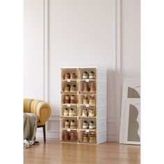 a wooden shoe rack with many pairs of shoes on it in front of a chair