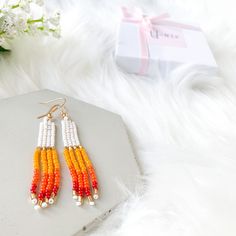 Beautiful White & multicolor hand-beaded earrings. These pairs of rainbow tassel earrings are the perfect earrings for you or for that special gift that you are looking for. They are made with high-quality seed beads and gold-plated ear wires, so if you like them, choose your variation and add click Add to cart and we will prepare them for you. You will receive one pair of earrings available in 2 options: sunset and purple sunset.  Item description:   Materials: -Seed beads in size 11/0 -Gold pl Trendy Beaded Earrings For Gift, Trendy Beaded Dangle Earrings With Ear Wire, Trendy White Dangling Bead Earrings, Trendy Dangle Beaded Earrings With Ear Wire, Trendy White Dangling Beads Earrings, Trendy White Earrings With Dangling Beads, Trendy White Tassel Drop Earrings, Summer Beaded Drop Earrings With Ear Wire, Trendy White Tassel Earrings For Summer