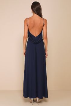 the back of a woman wearing a long blue dress