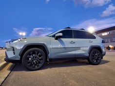 a white suv parked in front of a building