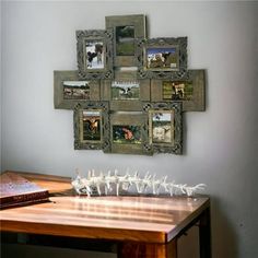 a wooden table topped with pictures and small white birds on top of it next to a book