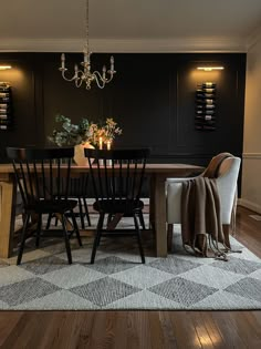 a dining room table with chairs and a chandelier