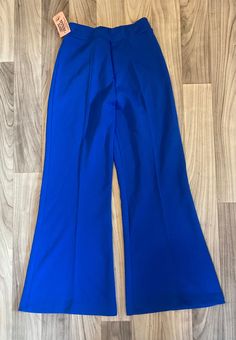 Vintage 1970's high waisted bellbottom  pants, poly/acrylic . Made by Upstairs Closet. Elastic waist.  Size 9, 25-30" waist, 30 " inseam, 41"length, 13.5"rise, 13" flat bell width (26" around) Unworn deadstock with original tags and in excellent, like new condition! Chic Blue Flare Wide Leg Pants, Blue Flare Bottoms For Party, Blue Flare Pants For Party, Chic Stretch Blue Flares, Fitted Blue Wide Leg Flares, High Waist Blue Flares, Flared Blue Party Bottoms, Blue Flared Party Bottoms, Blue Flare Party Bottoms