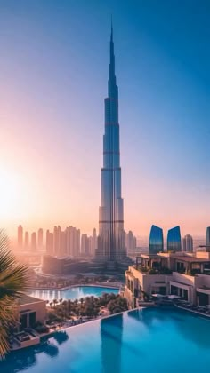 the burj tower towering over the city is seen from an outdoor swimming pool