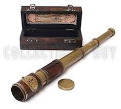 an old wooden telescope next to a coin