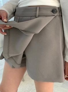 Details This skort is featured in low rise, pleats with pants inside. ● Pleats with wrapped ● Side zipper ● Pants inside ● Low rise Care Hand Wash Cold Model size 5'2" waist (25"-26") model is wearing S Product Info Size: S, M Color: Beige, Grey, Black Fabric: 97% polyester, 3% spandex [Our Policy] Exchange/refund are available within 7 days after receiving the product(s). Exchange/refund are not available for any worn product(s) or products damaged by customers. Please understand ivory and whit Solid Short Pleated Bottoms, Trendy Pleated Bottoms With Short Inseam, Pleated Short Skort For Work, Trendy Pleated Bottoms, Trendy Pleated Shorts, Trendy Pleated Short Bottoms, Trendy Short Pleated Bottoms, Elegant Pleated High-waisted Shorts, Elegant Pleated Short Bottoms