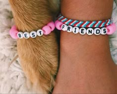 a dog's paw and two bracelets with the words best friends on them